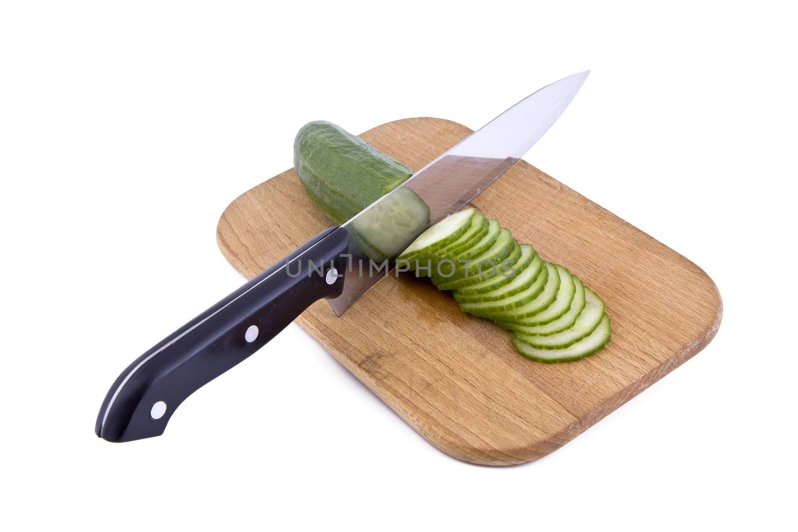 Fresh green cucumber with a kitchen knife and cutting board