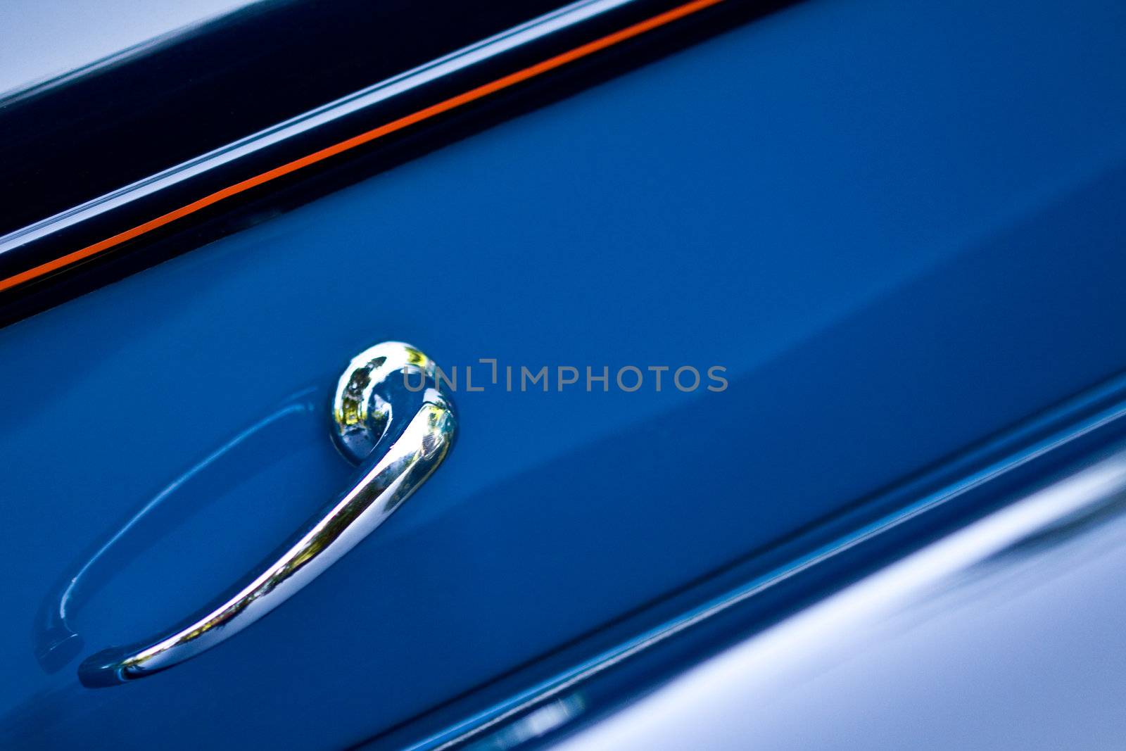 Closeup on shiny door handle of retro car