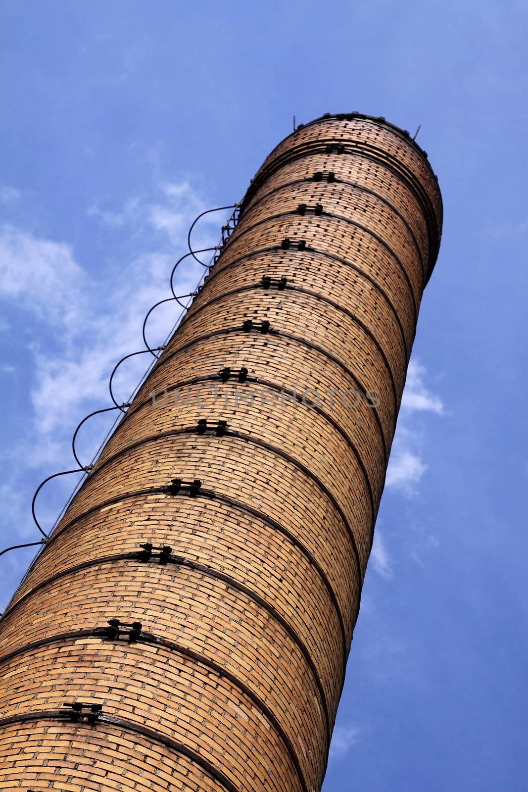 Brick chimney on the background of blue sky