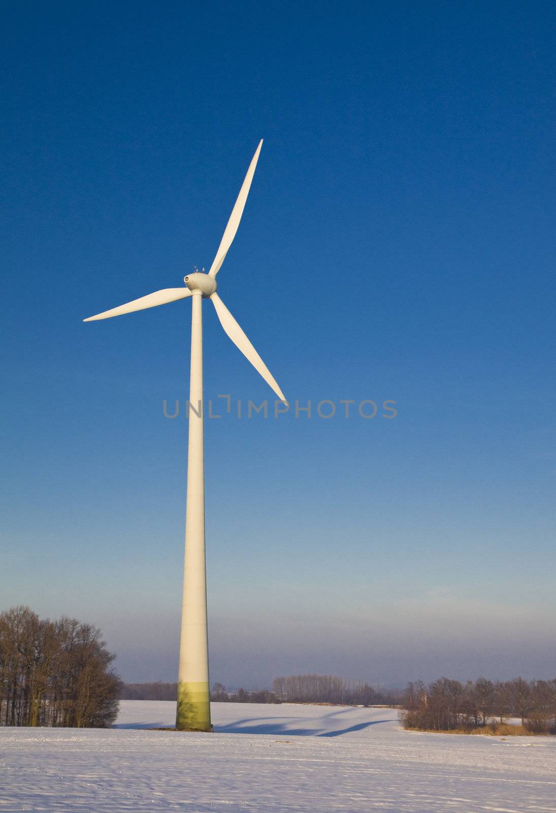 Windmill against a blue sky in winter, alternative energy source