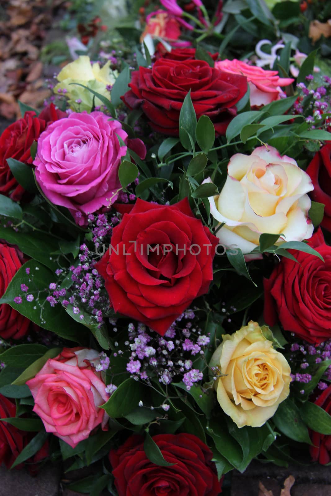 Multicolored roses in a mixed floral arrangement