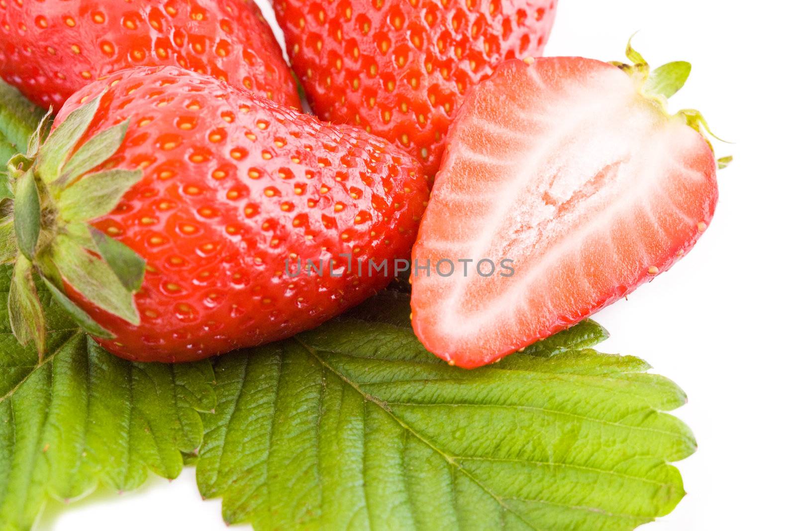 Closeup on fresh strawberries isolated on white background