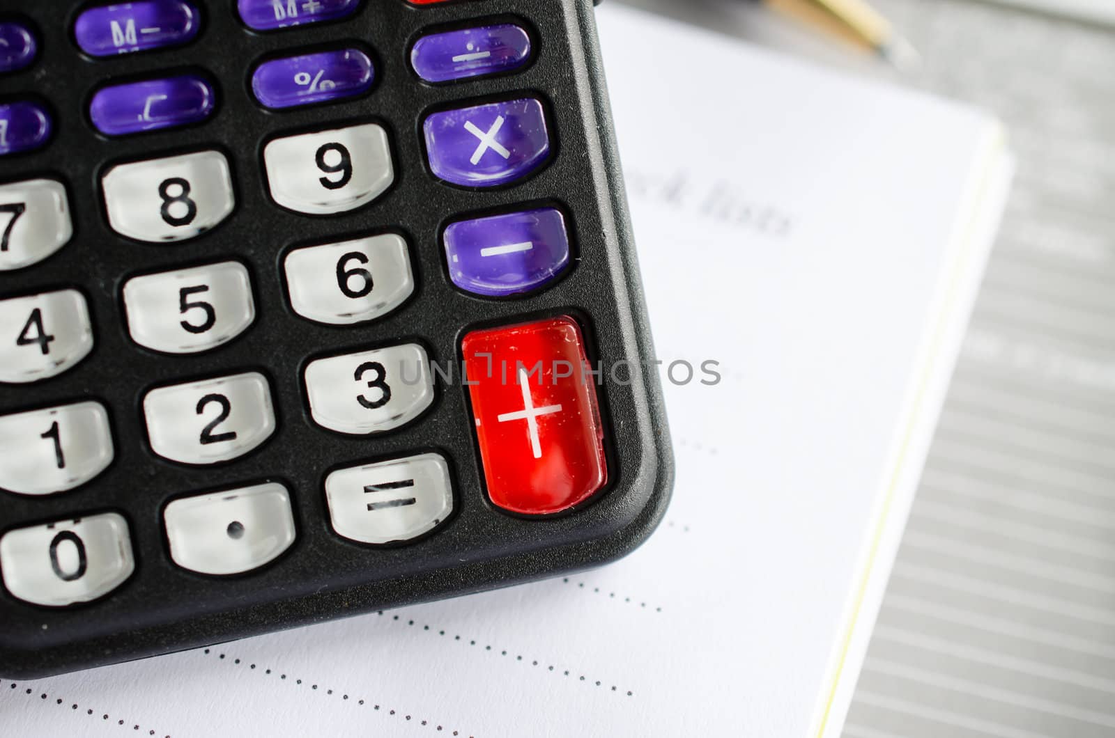 calculator and notebook on grey background
