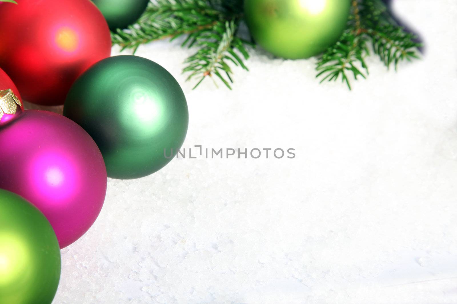 Composition of colorful Christmas baubles on snow