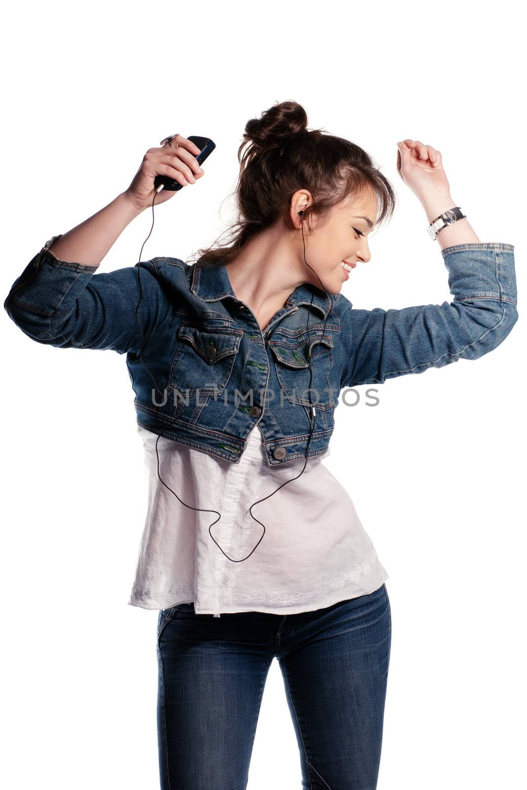 Dancing girl with earphones in denim isolated on white