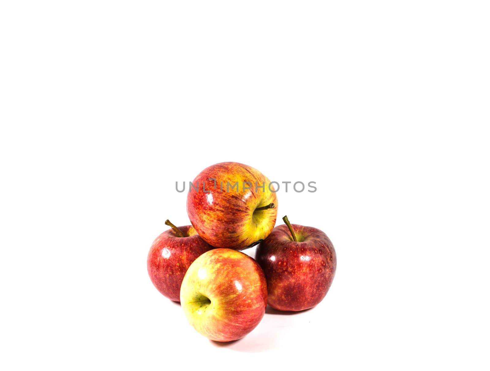 Red apples in white bowl, on white