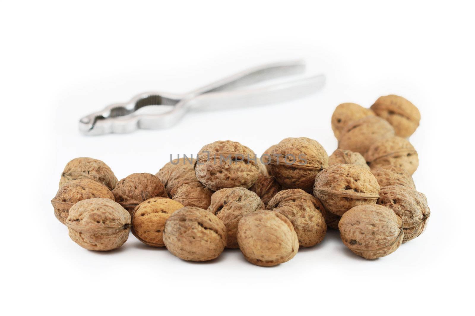 Walnuts and nutcracker isolated on white background