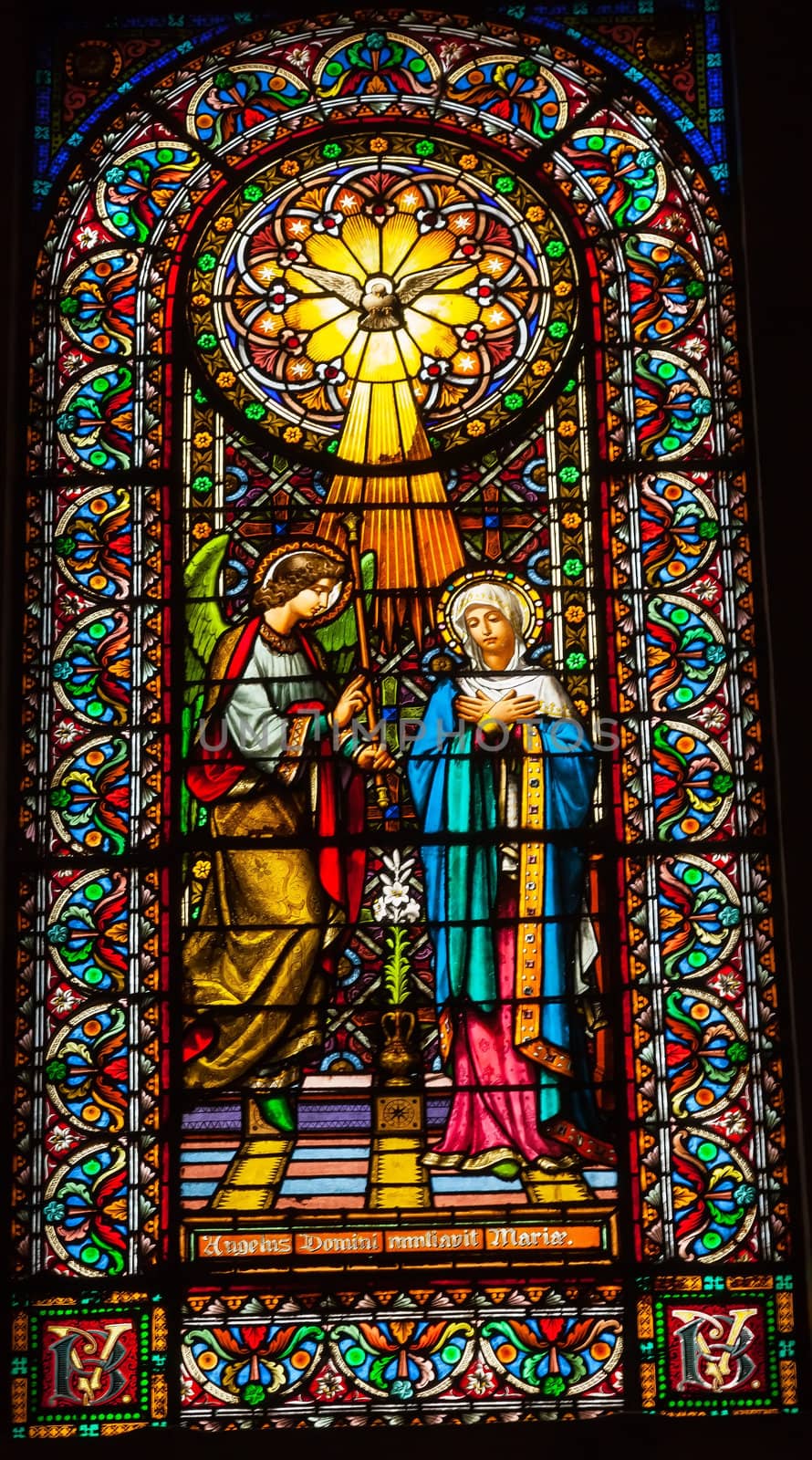 CATALONIA, SPAIN--OCTOBER 18, 2012  Stained glass angel tells Mary she will have Jesus holy spirit in Monestir Monastery of Montserrat, Barcelona, Catalonia, Spain on October 18, 2012.  Founded in the 9th century, destroyed in 1811 when French invaded Spain. Rebuilt in 1844 and now a Benedictine monastery.  Placa de Santa Maria.