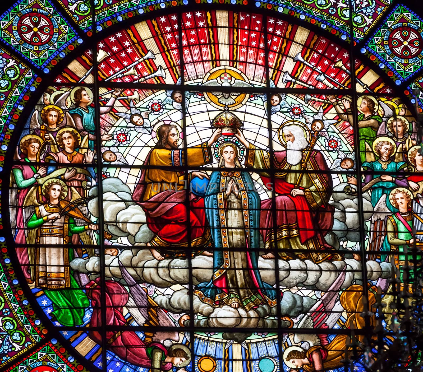 Stained glass Jesus crowning Mary angels God the father in rose window basilica inside Monestir Monastery of Montserrat, Barcelona, Catolonia, Spain.  Founded in the 9th Century, destroyed in 1811 when French invaded Spain. Rebuilt in 1844 and now a Benedictine Monastery.  Placa de Santa Maria