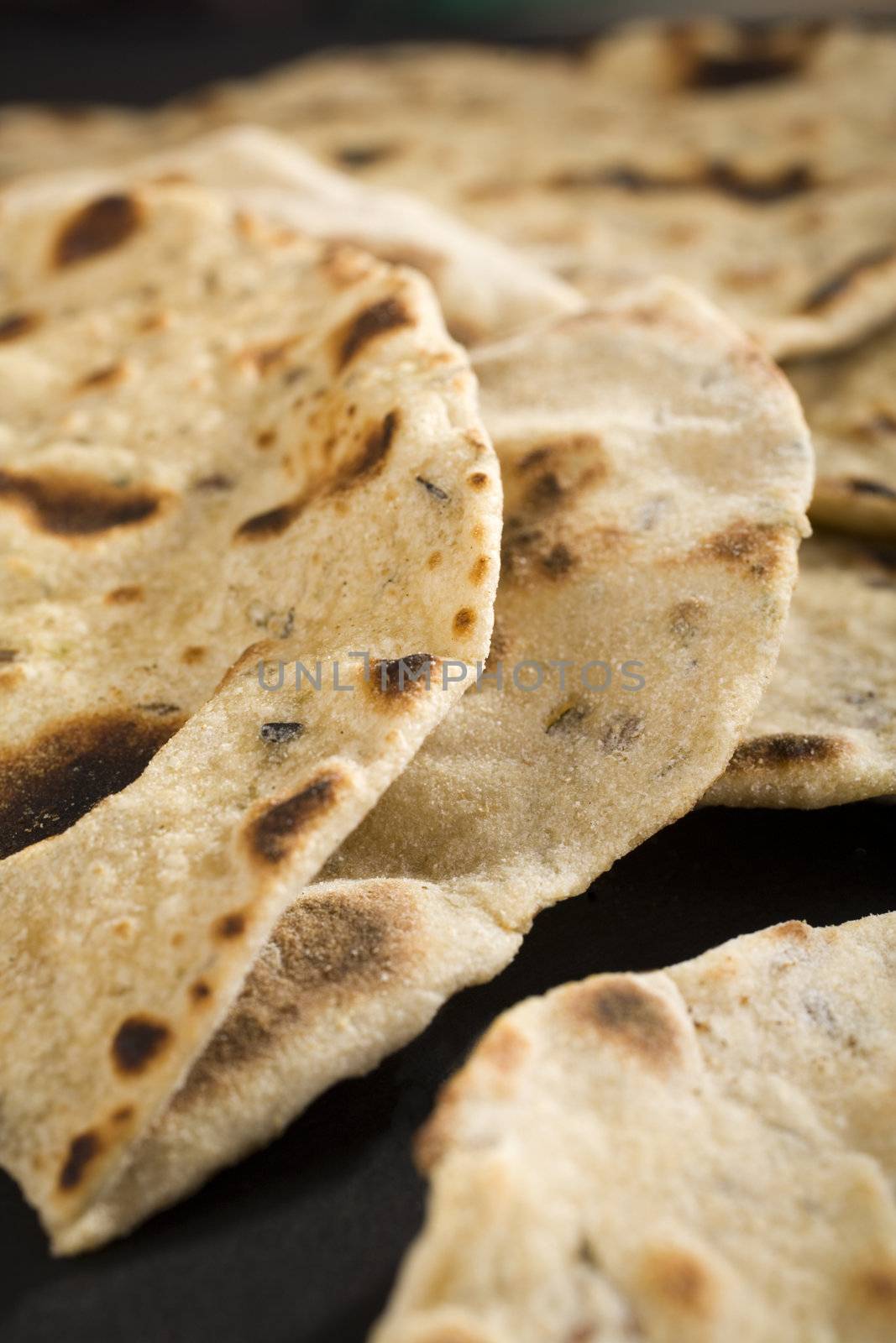 Close up shot of indian chapatis, or roti, traditional unleavened bread to eat with curry. Shallow DOF.