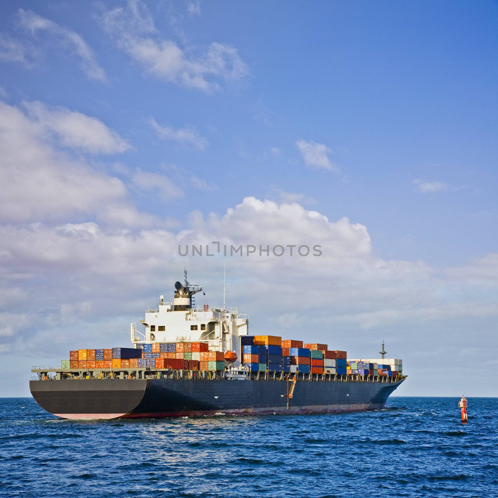 Heavily Laden Container Ship Leaving Port by Travelling-light