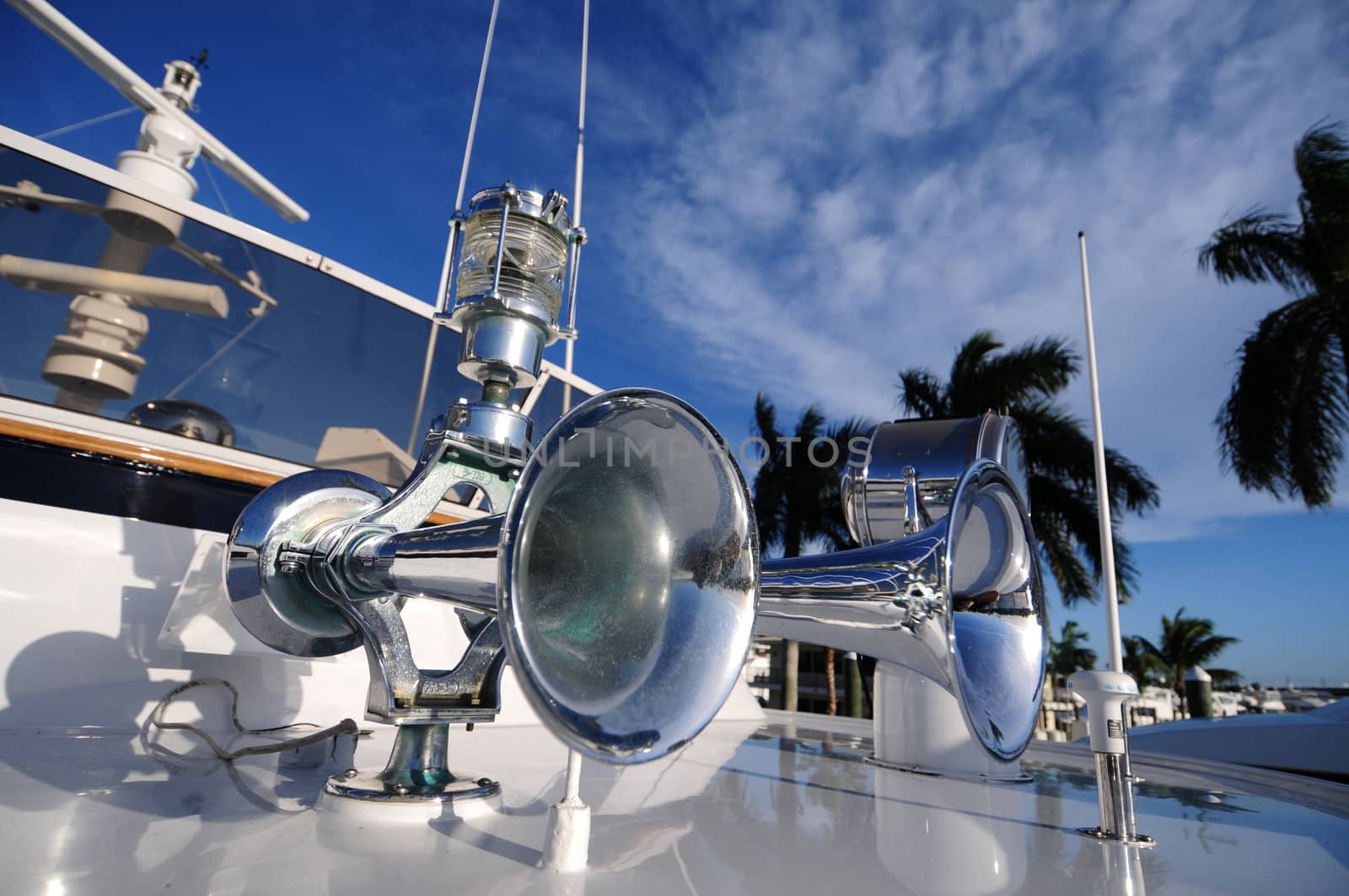 boat horn and light on a yacht with palm trees in background