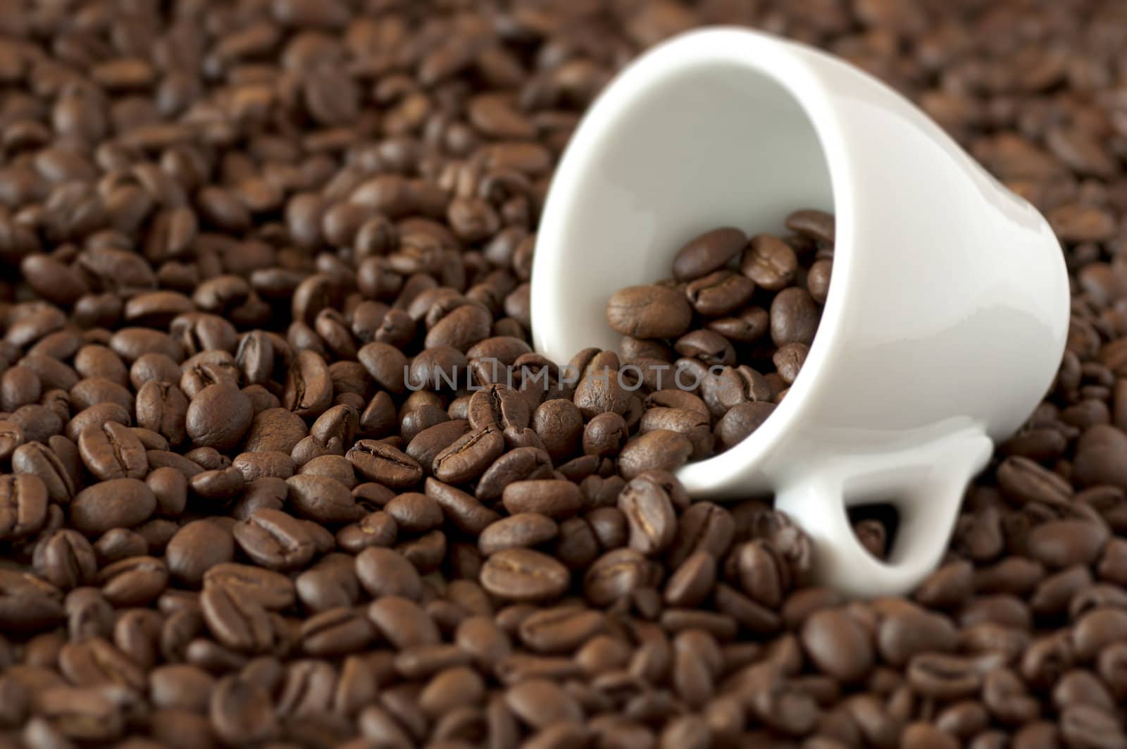 cup lying on coffee beans