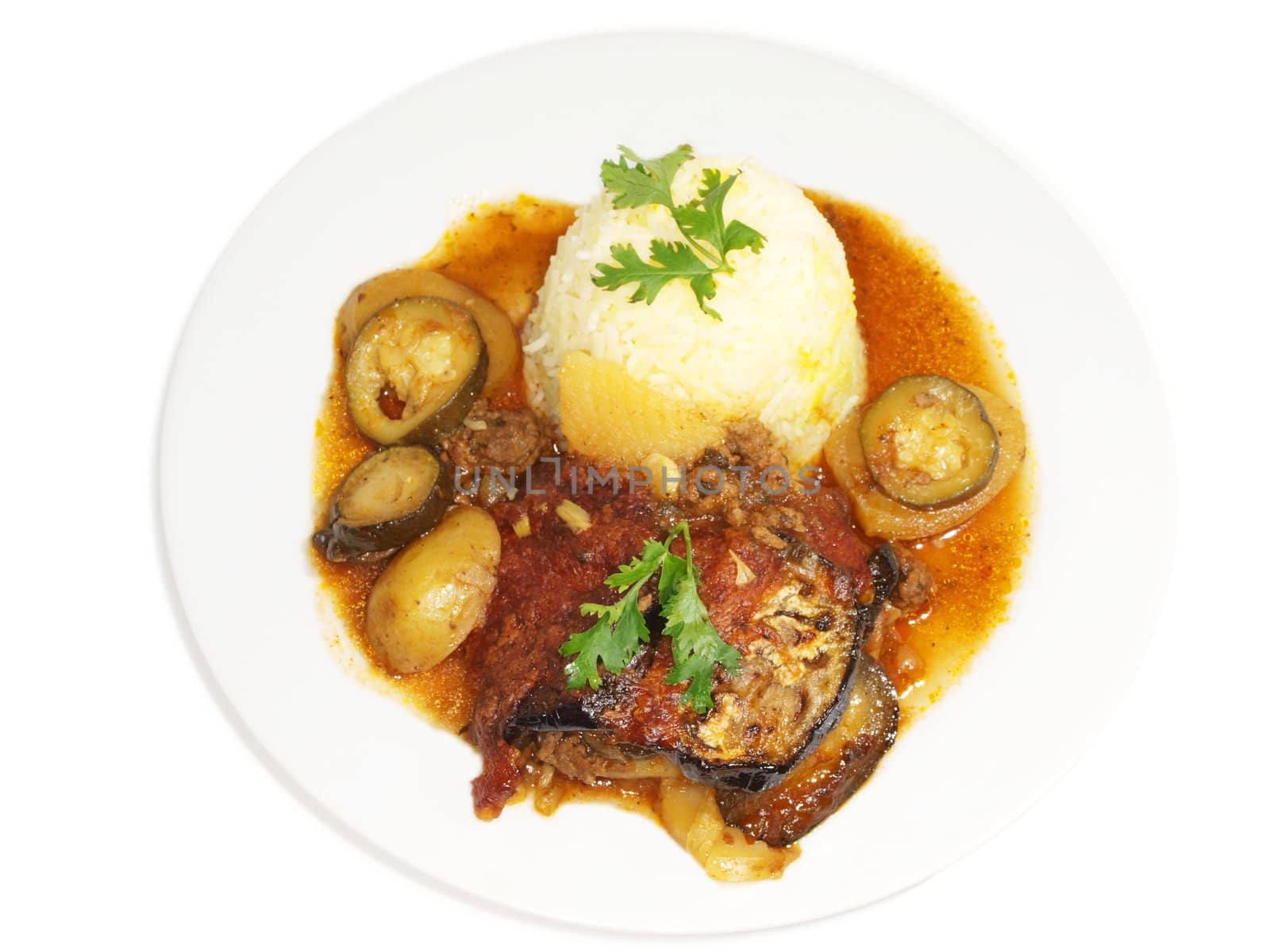 Eggplant dish, fried vegetables in juicy sauce, next to bowl of rice