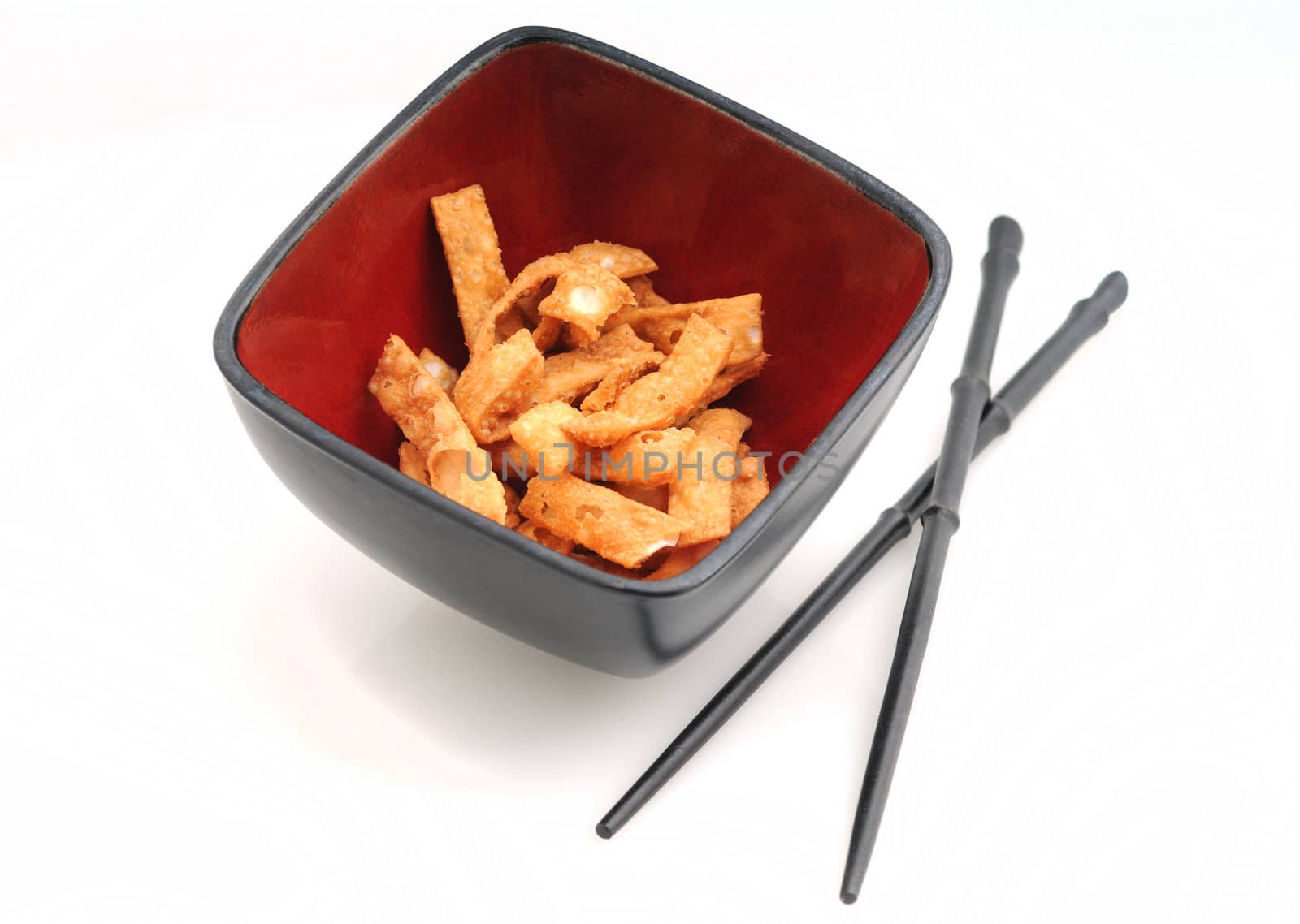 wonton strips with chopsticks served for an appetizer