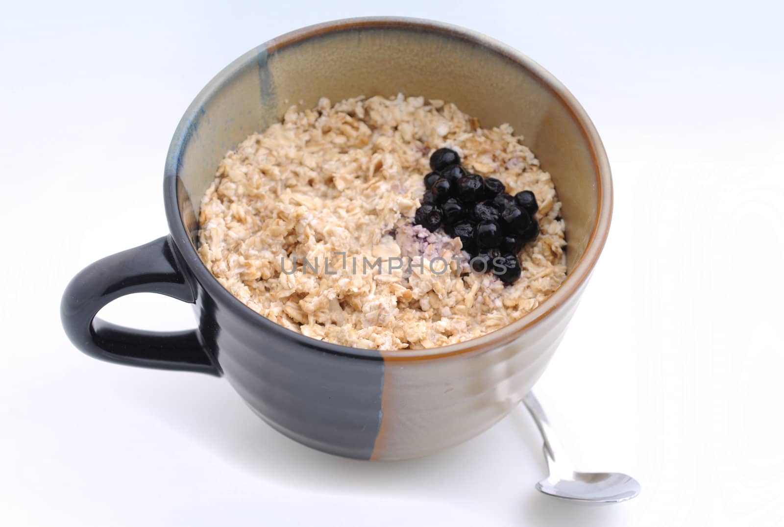 Hearty breakfast of oatmeal and blueberries in large mug