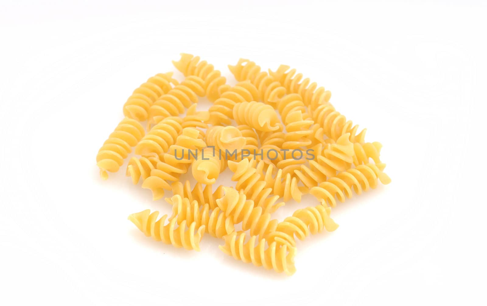 raw rotelli pasta on white background