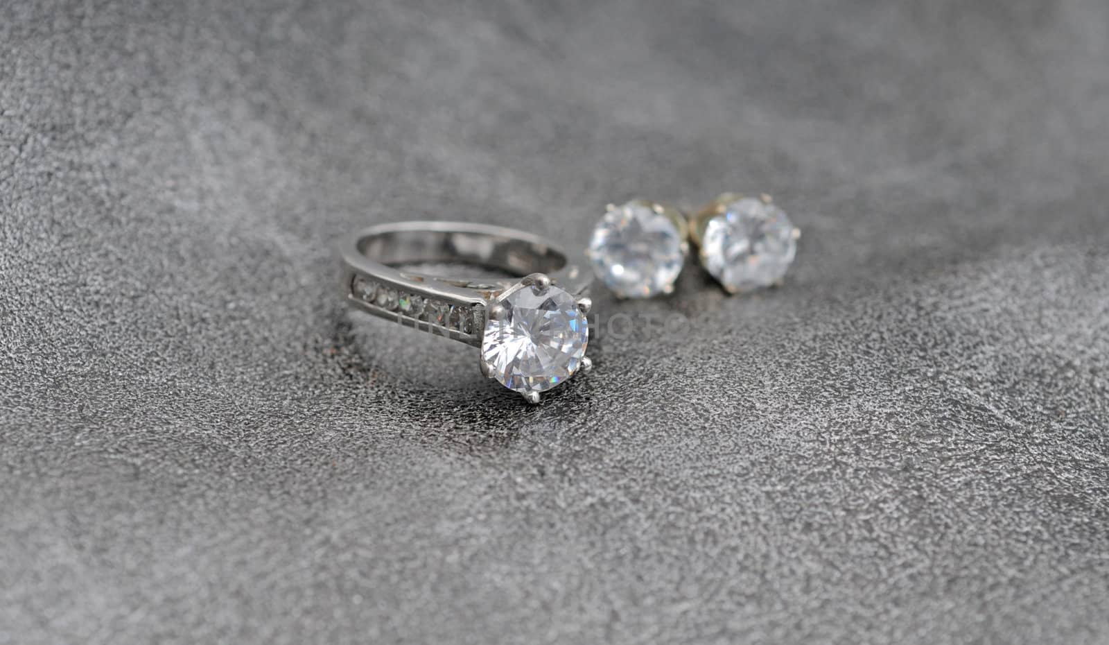 diamind jewelry consisting of engagement ring and earrings