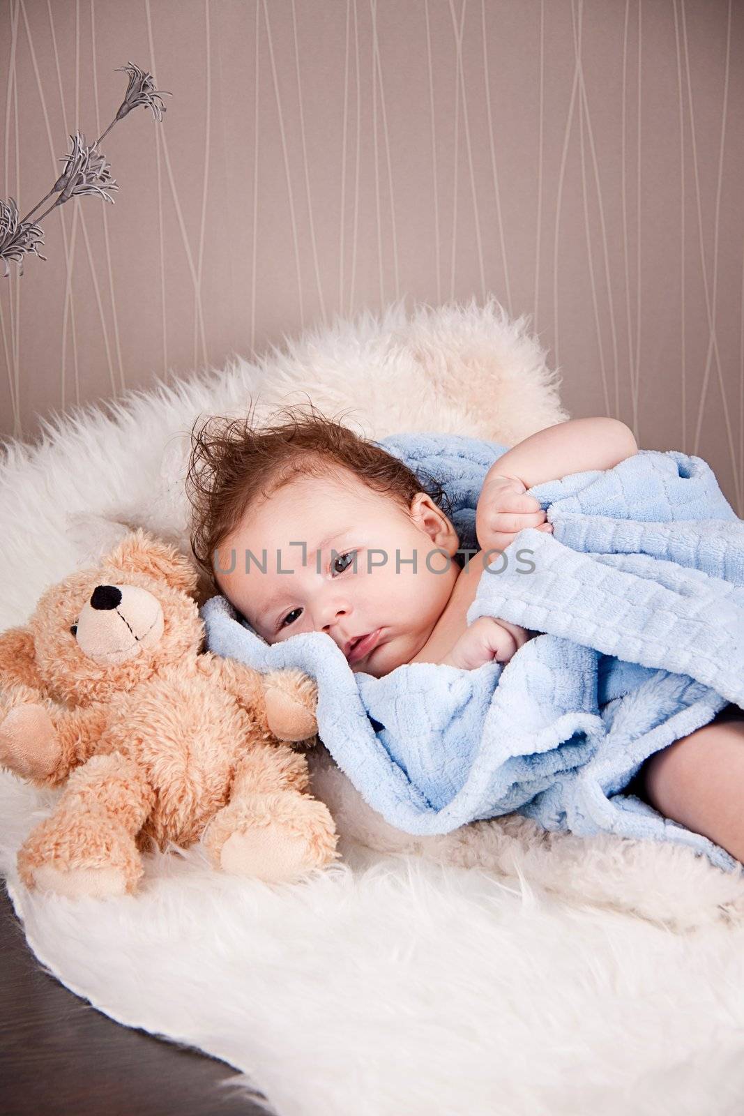 cute little baby todler infant lying on blanket with teddy bear 