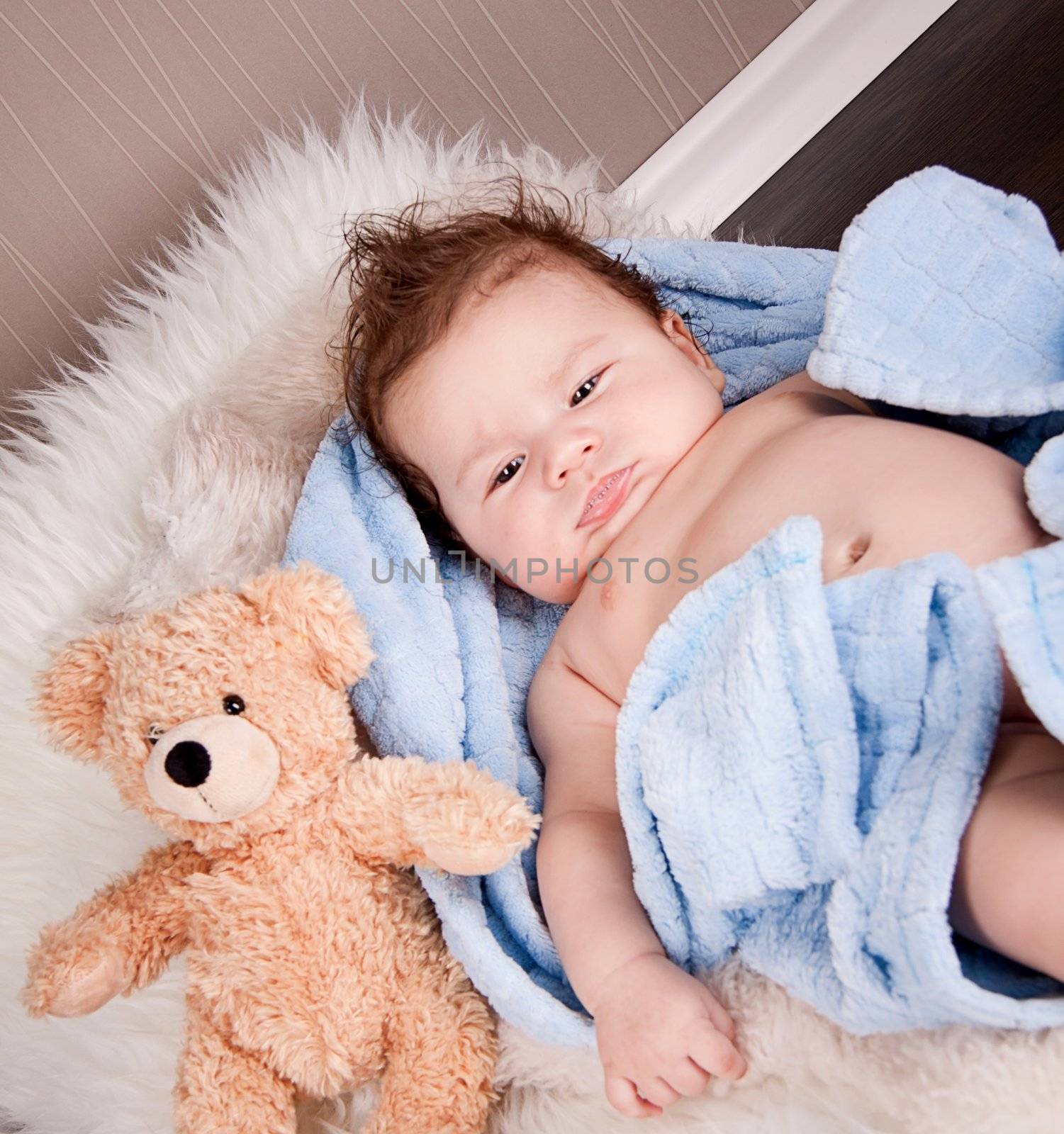 cute little baby todler infant lying on blanket with teddy bear 
