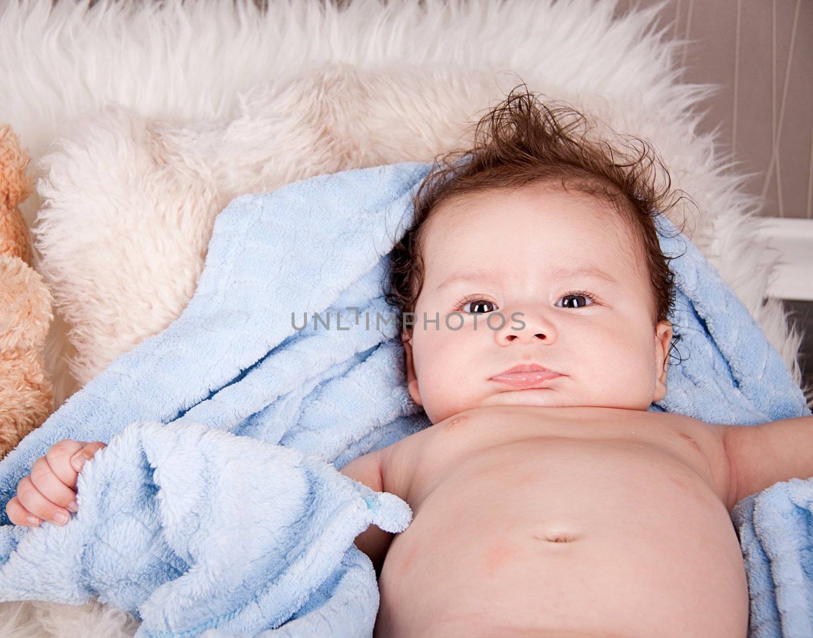 cute little baby todler infant lying on blanket with teddy bear 