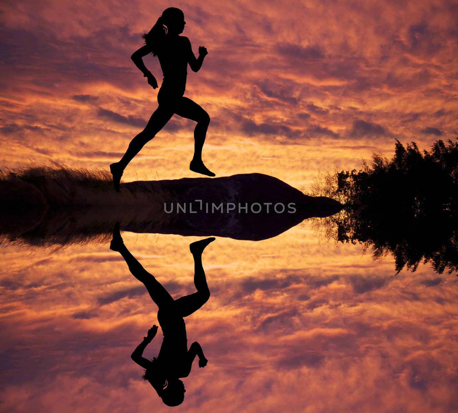 Female runner silhouette against the sunset 