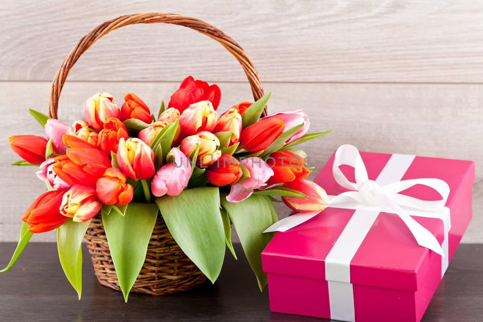 pink present with ribbon and colorful tulips festive easter decoration