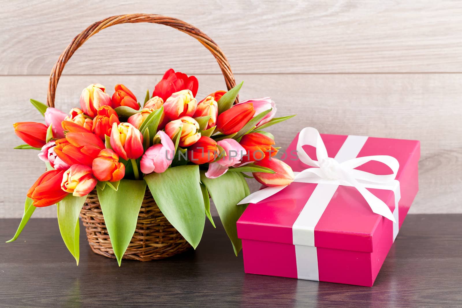 pink present with ribbon and colorful tulips festive easter decoration