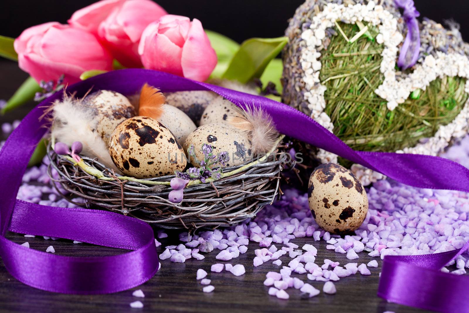 pink tulips and brown eggs with purple ribbon colorful easter decoration