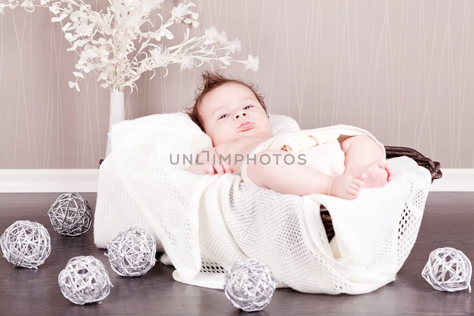 sweet little baby infant toddler on white  blanket in basket at home