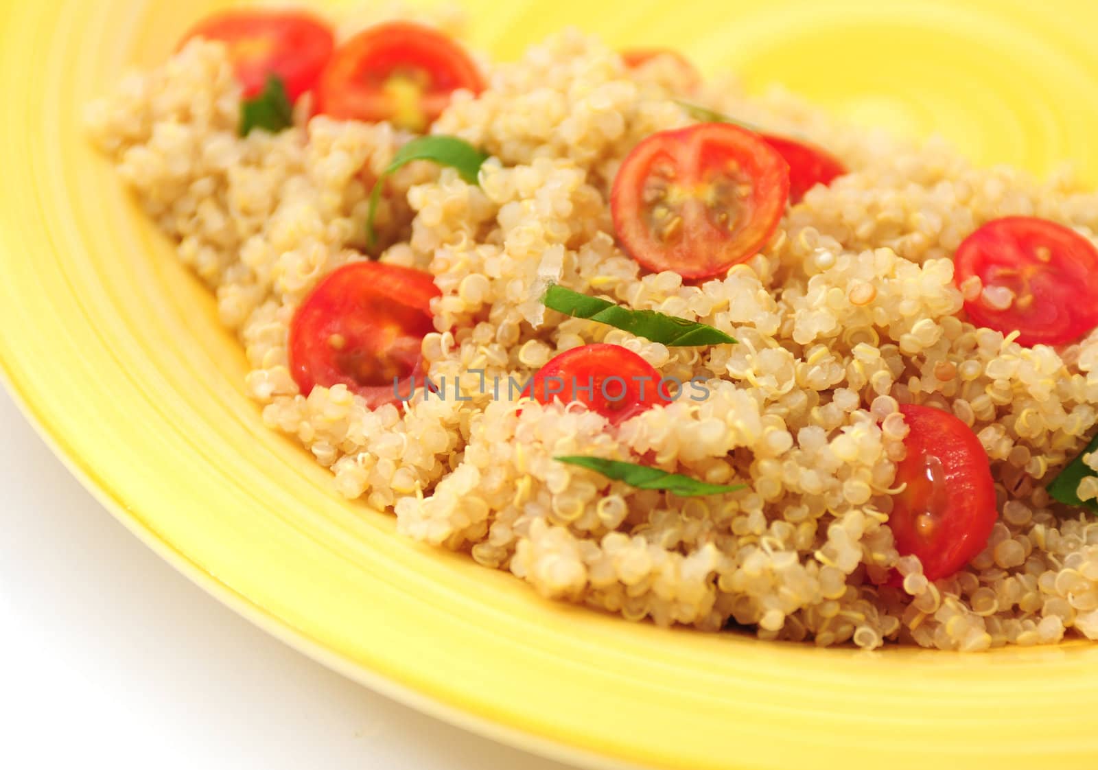 A healthy quinoa side dish with tomatoes and basil