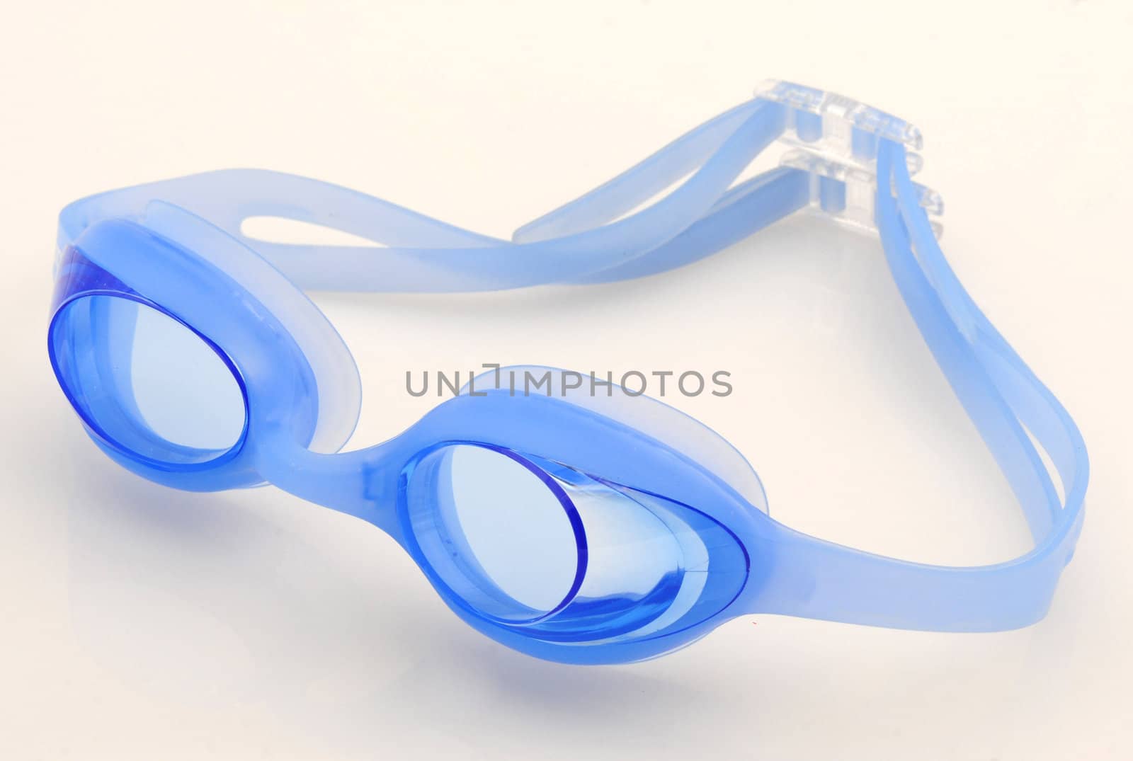 Blue swimming goggles isolated on white by ftlaudgirl