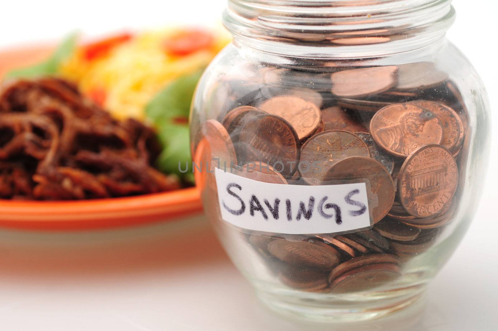 Saving money with a jar of pennies from the savings on the food budget
