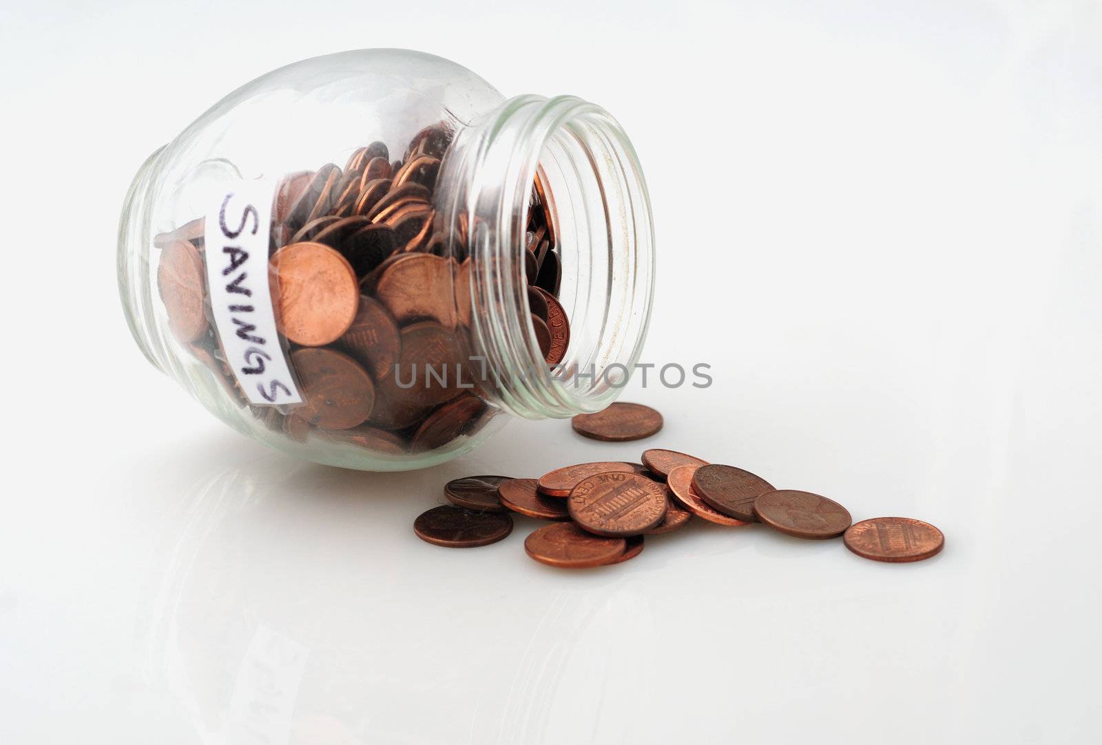 Pennies spilling out of a jar of pennies to signify dipping into savings