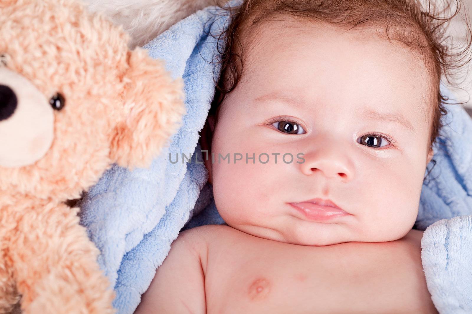 cute little baby todler infant lying on blanket with teddy bear 