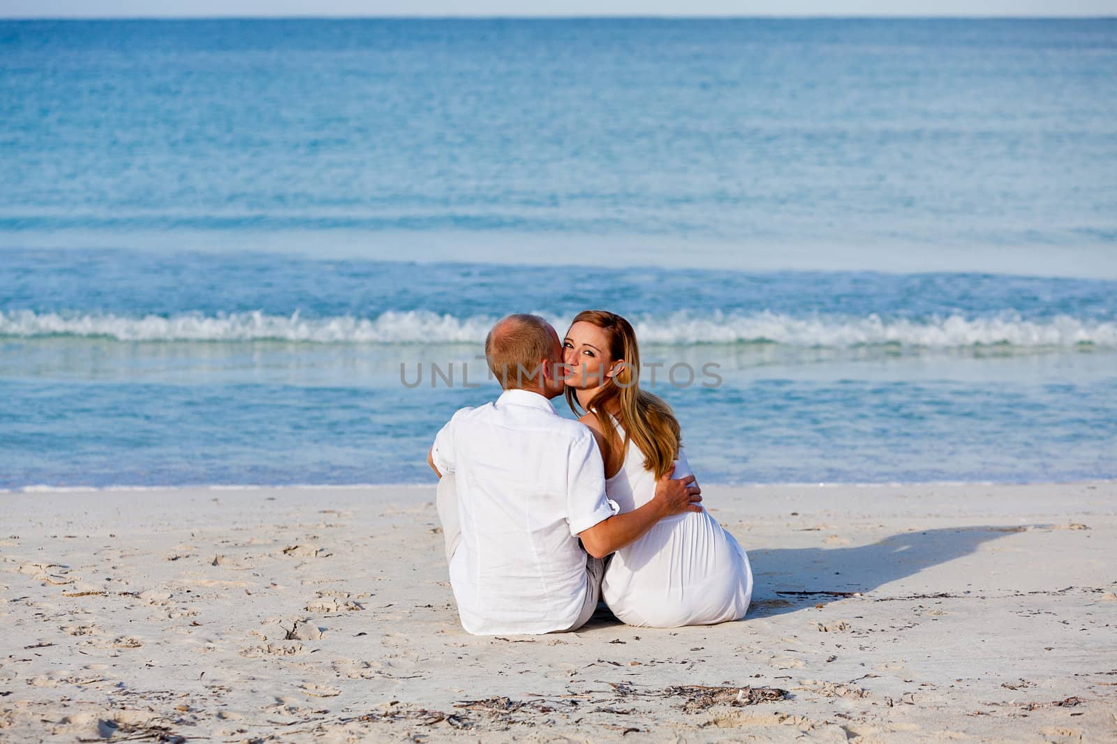 happy young couple in love having fun on the beach blue sky and sunshine 