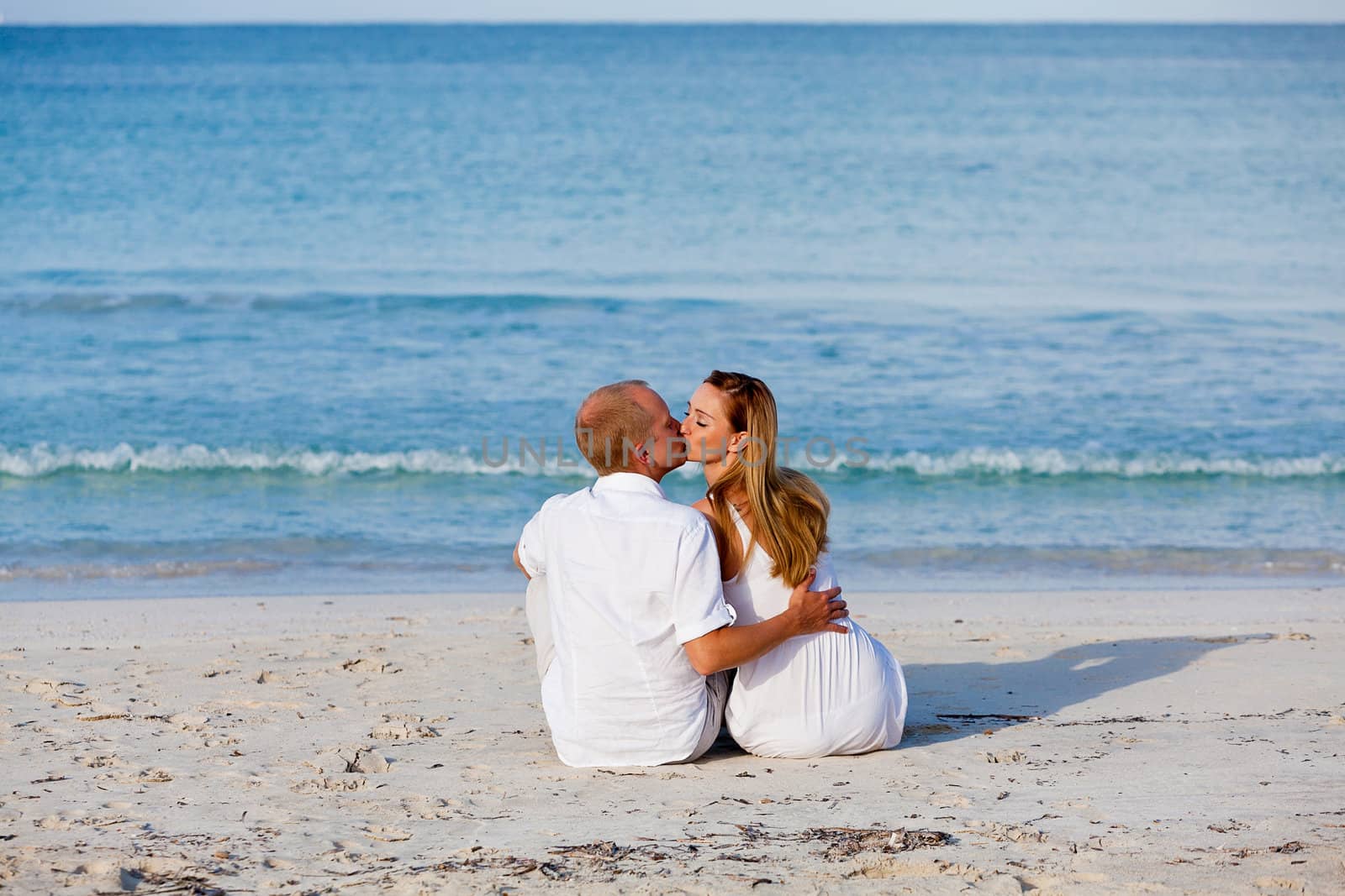 happy young couple in love having fun on the beach blue sky and sunshine 