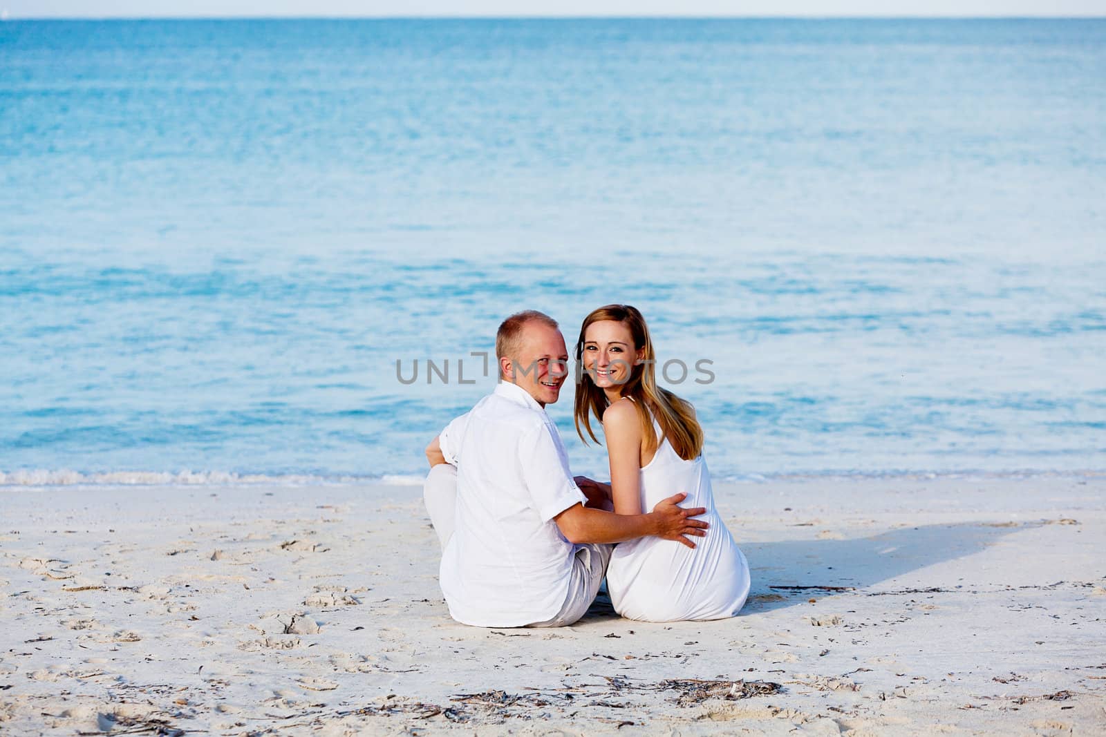 happy young couple in love having fun on the beach blue sky and sunshine 