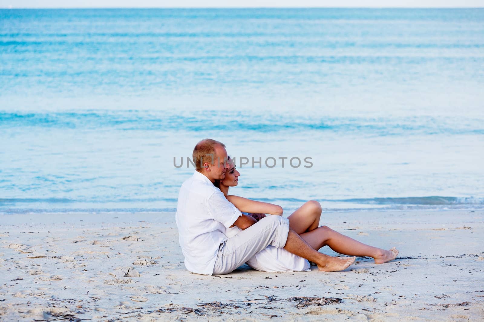 happy young couple in love having fun on the beach blue sky and sunshine 