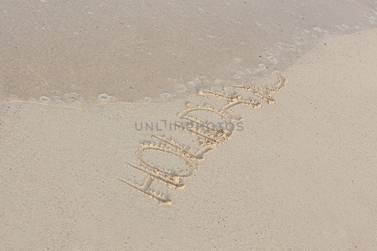 hand writing in sand in summer holiday vacation on beach 