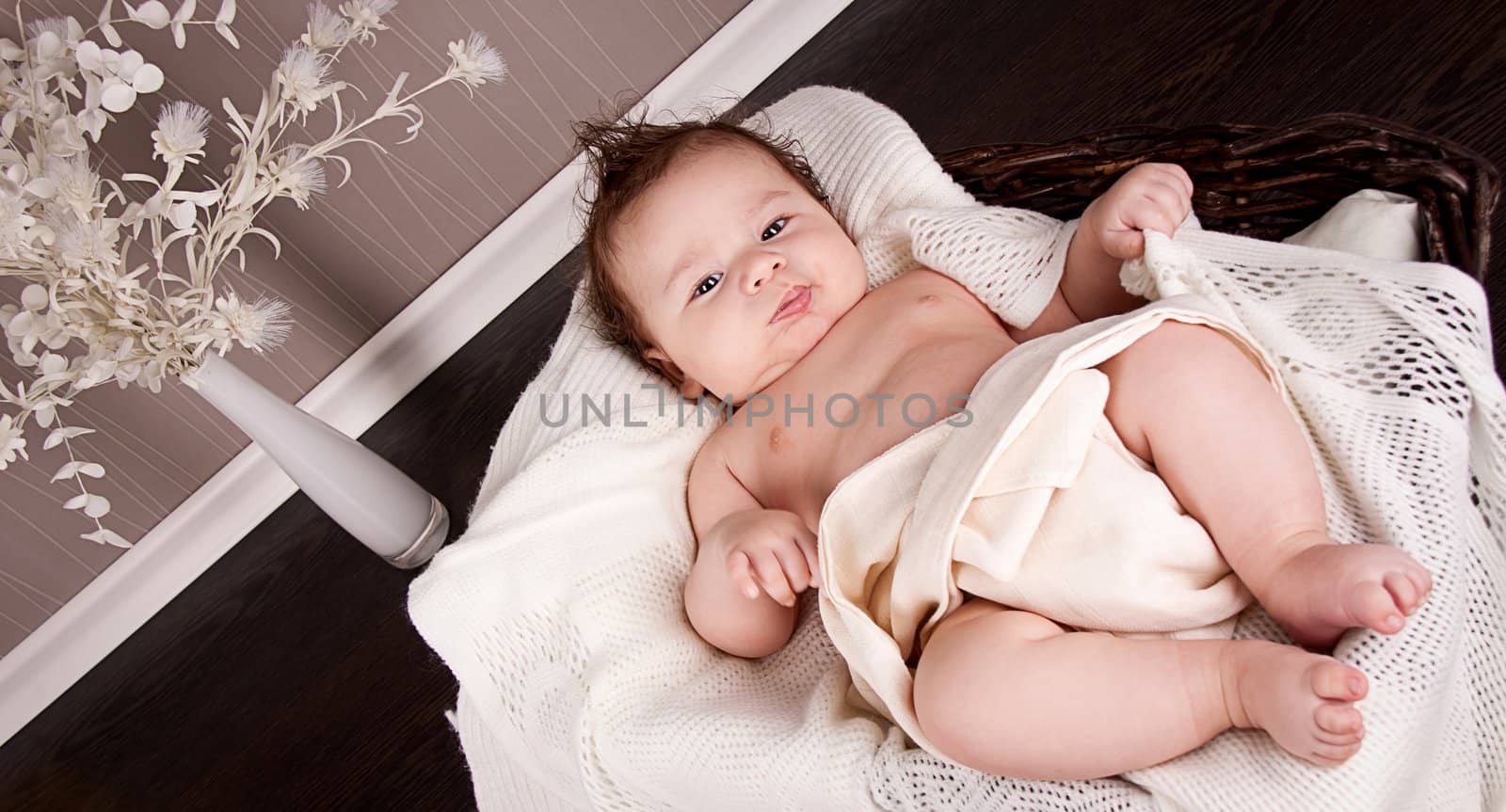 sweet little baby infant toddler on white  blanket in basket at home
