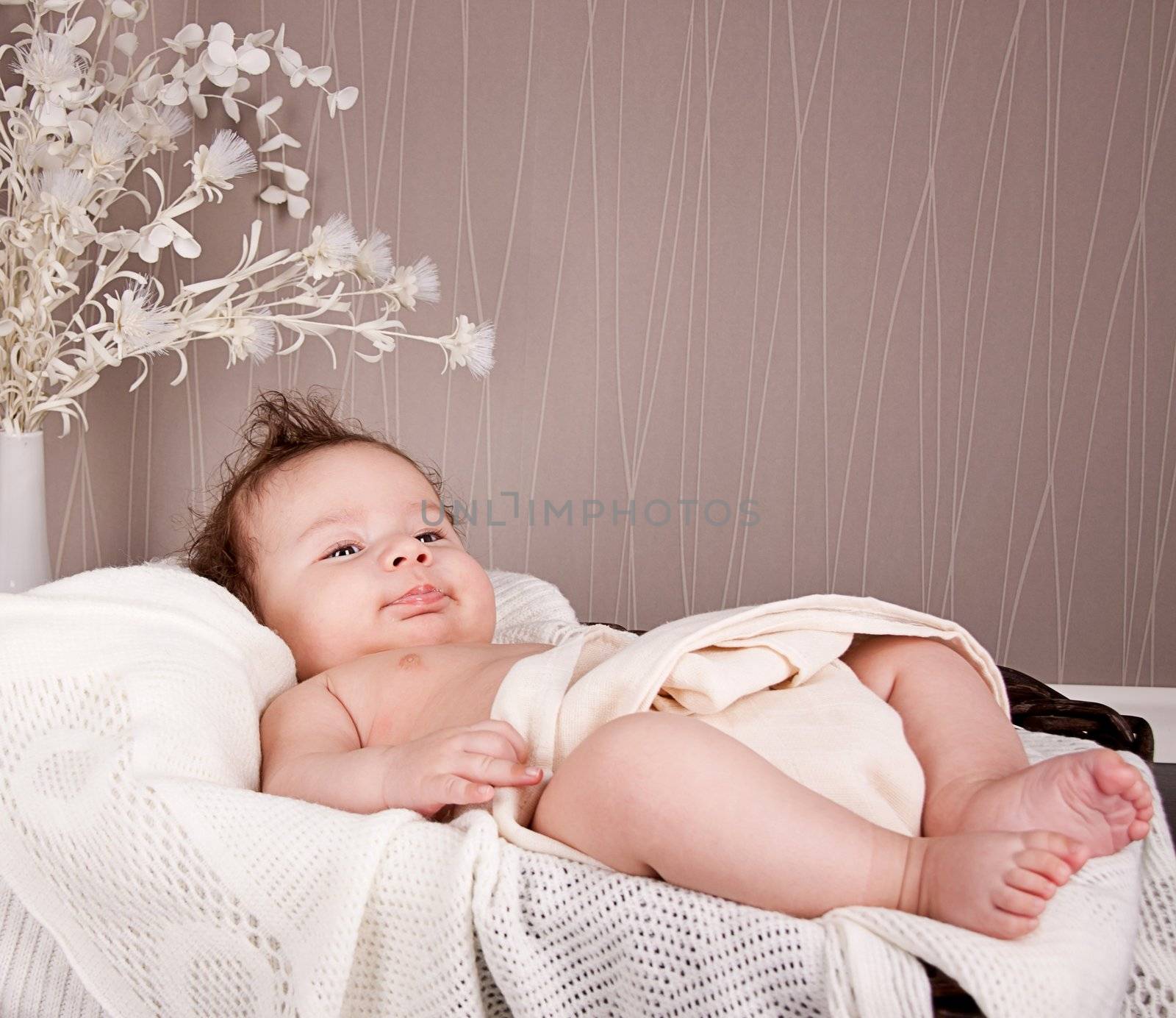 sweet little baby infant toddler on white  blanket in basket at home
