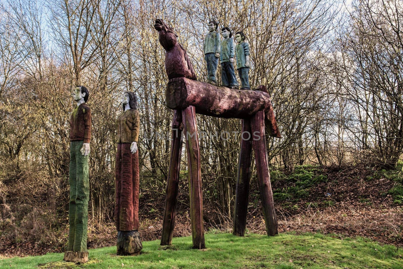 Carved wooden horse and people situated by the side of a main road in Ashford Kent