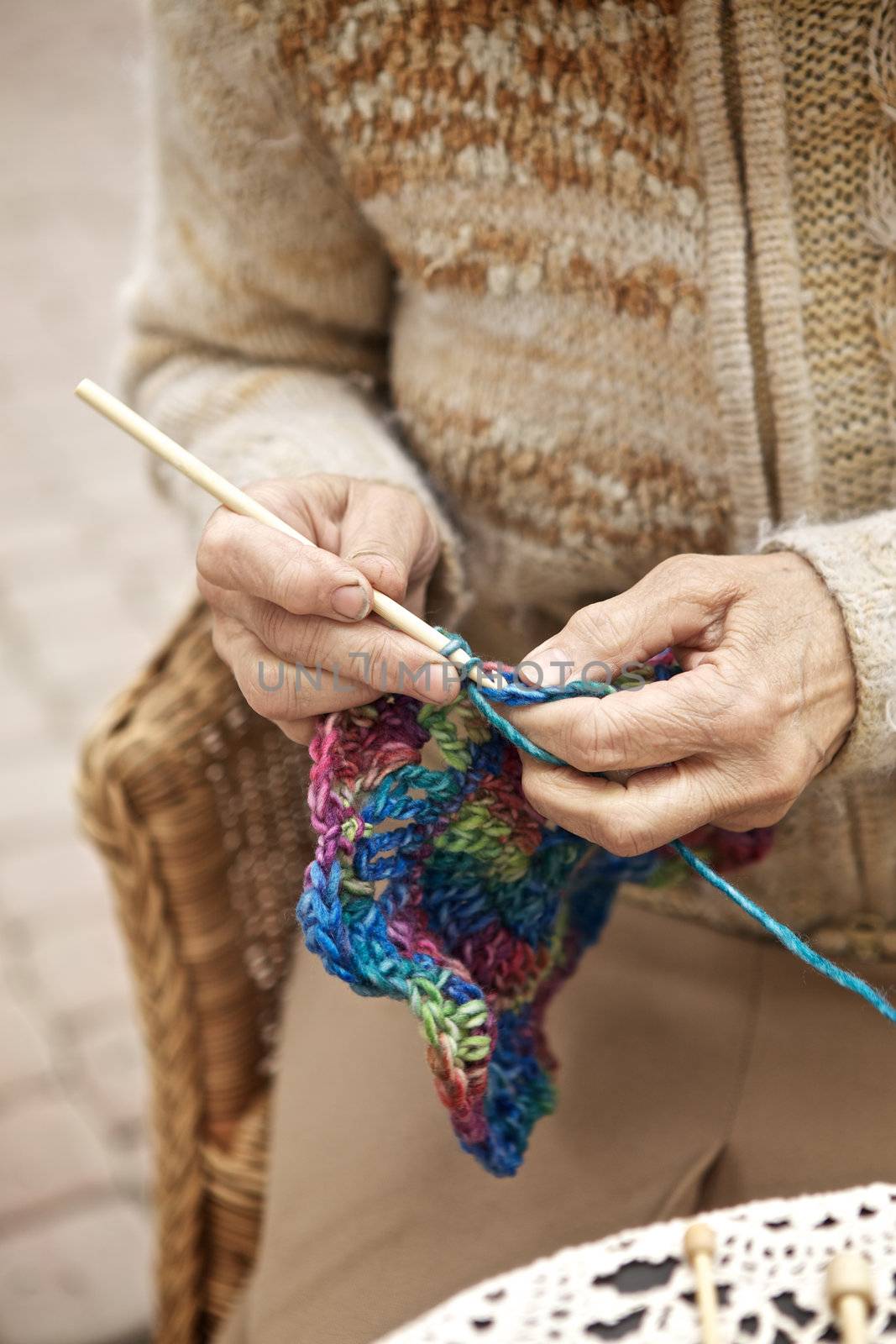 hands of old woman knitting wool, close up
