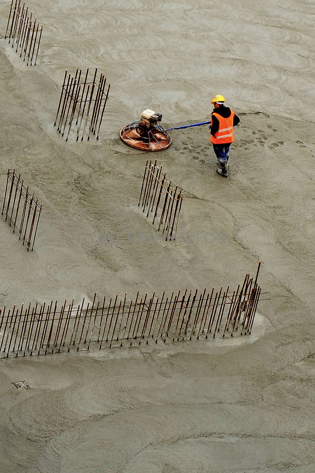 Construction worker on new cement for polishing surface