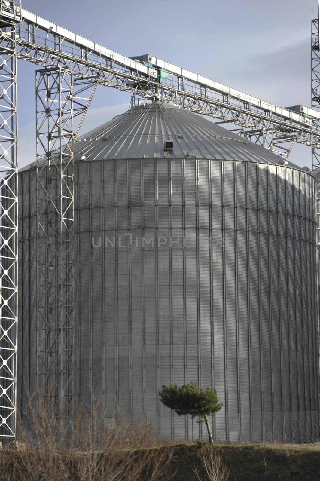 A row of shiny, steel silos