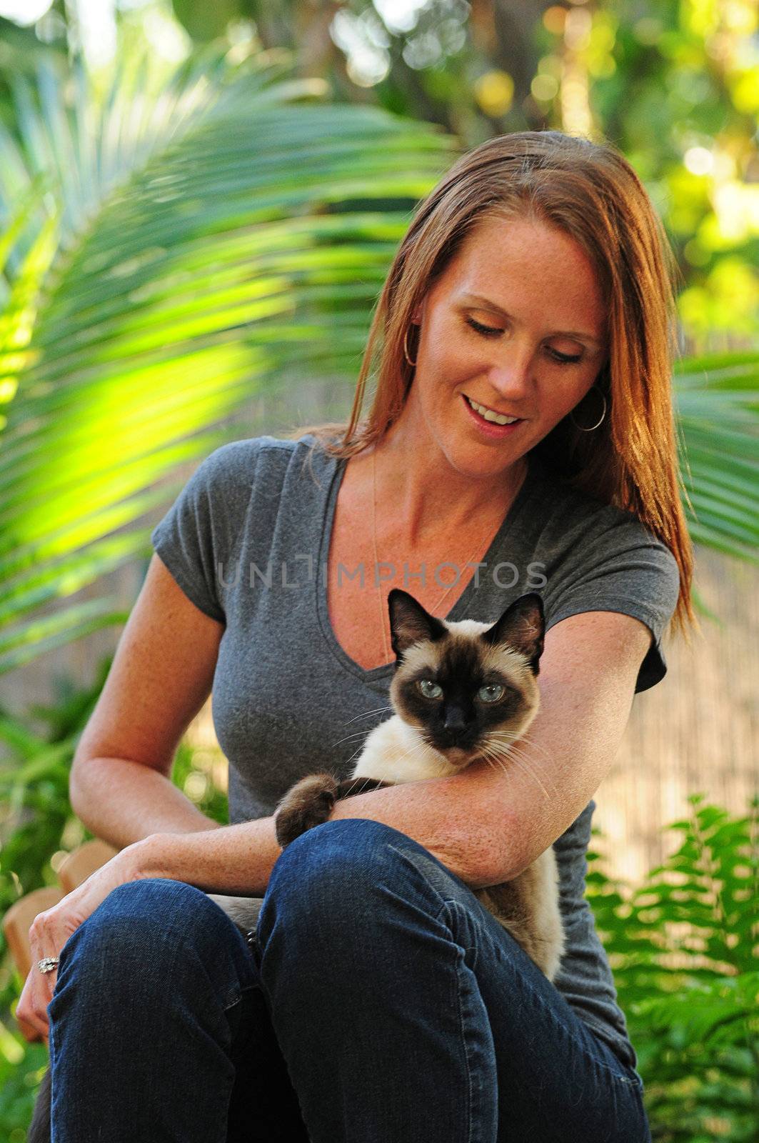 Young woman holding cat by ftlaudgirl