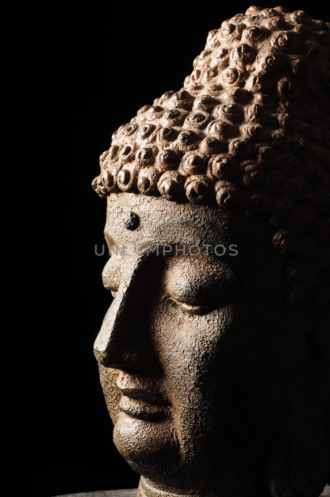 Buddha head isolated on black background