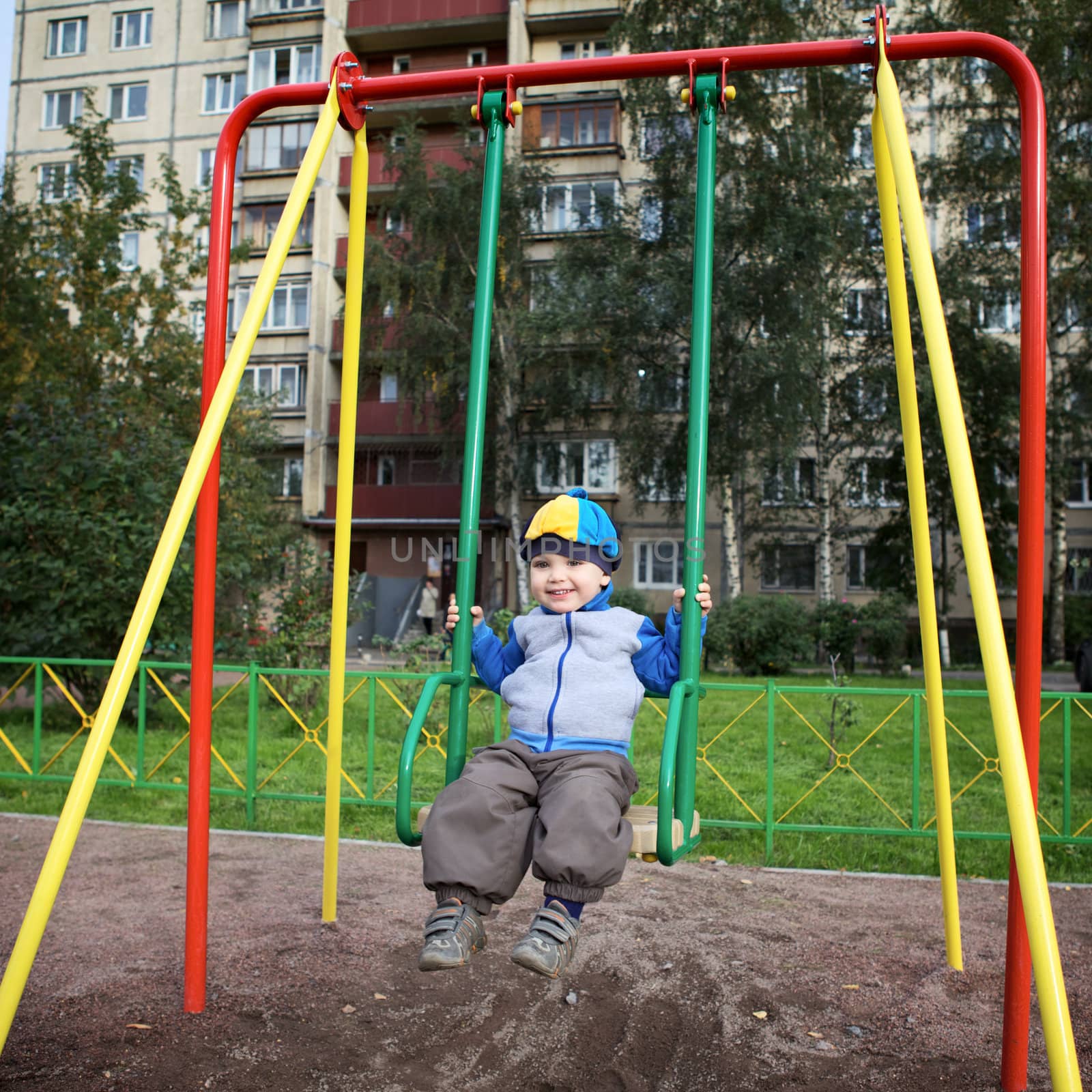 little boy teeter on playground at autumn