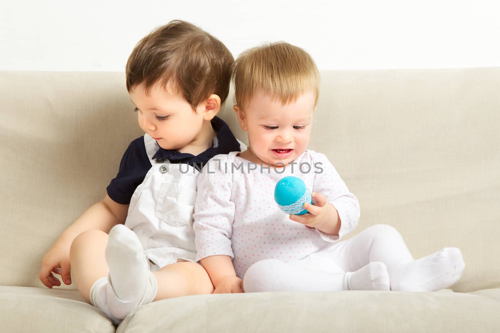 two little boys sitting on couch and playing